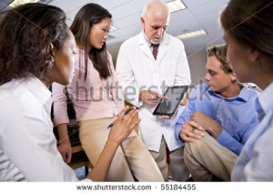 stock-photo-professor-wearing-lab-coat-having-discussion-with-college-students
