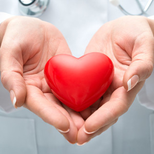 Doctor's hands holding an image of a heart