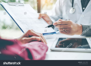 stock-photo-doctors-and-patients-sit-and-talk-at-the-table-near-the-window-in-the-hospital