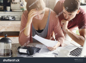 stock-photo-young-couple-calculating-their-domestic-budget-together-in-kitchen